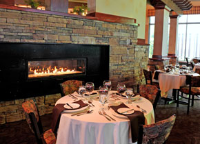 table set in dining hall with fireplace in the background